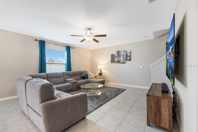 tiled living room with a textured ceiling and ceiling fan