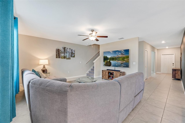 tiled living room with ceiling fan