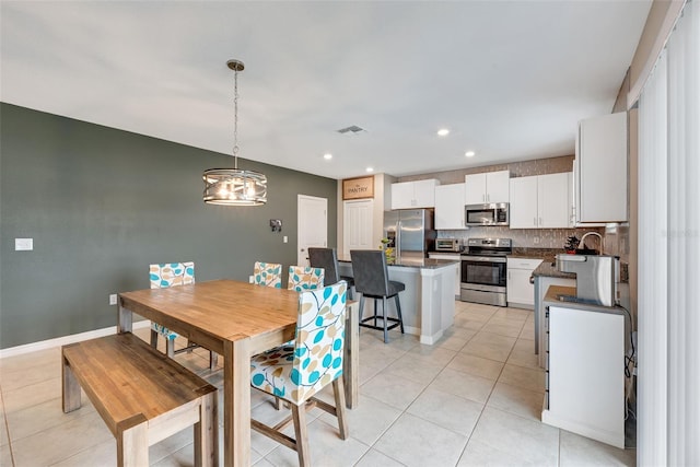 dining room with sink and light tile patterned floors