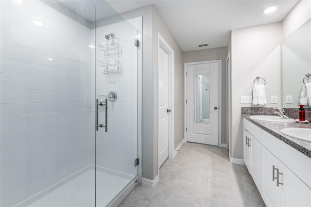 bathroom with a shower with door and vanity