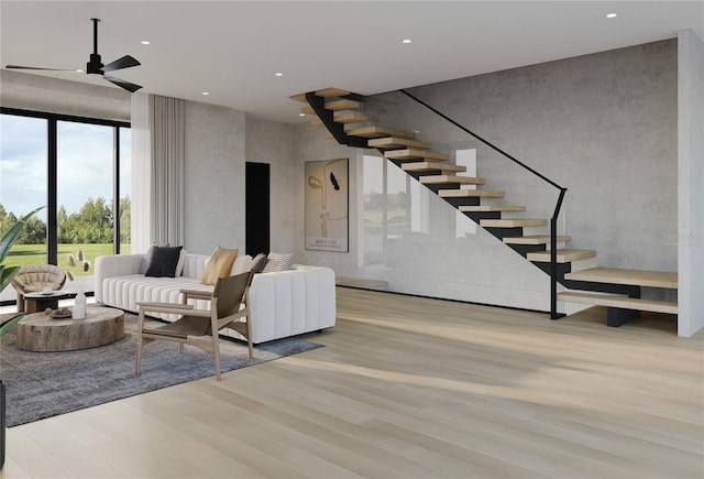 living room with ceiling fan and light hardwood / wood-style floors