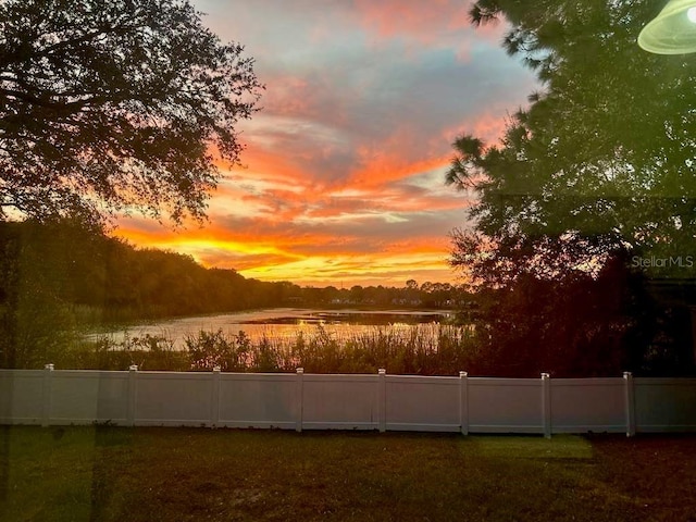 yard at dusk with a water view