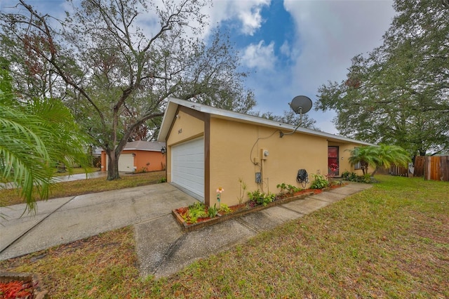 view of home's exterior featuring a garage and a yard