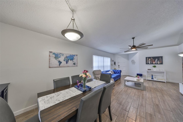 dining room with a textured ceiling and ceiling fan