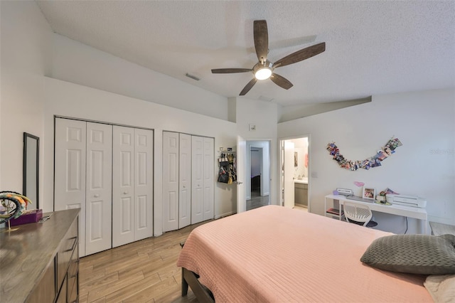 bedroom featuring ceiling fan, a textured ceiling, connected bathroom, and light hardwood / wood-style flooring