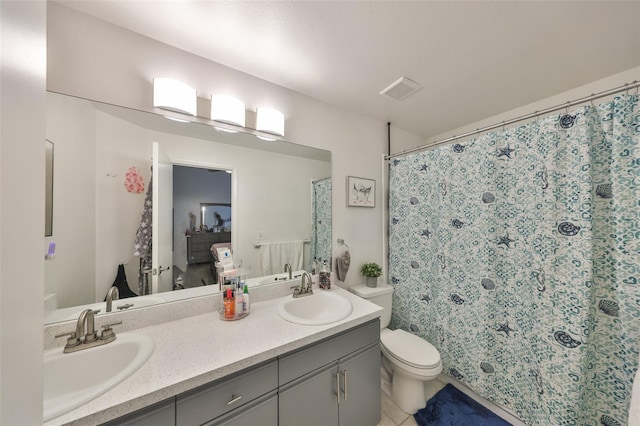 bathroom featuring toilet, vanity, and a shower with shower curtain