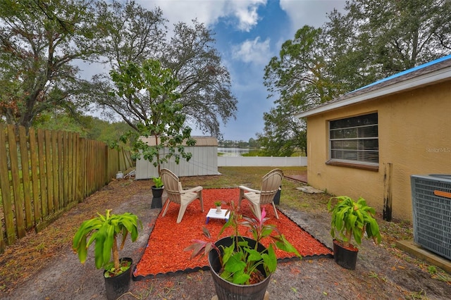 view of patio featuring central AC and a storage shed