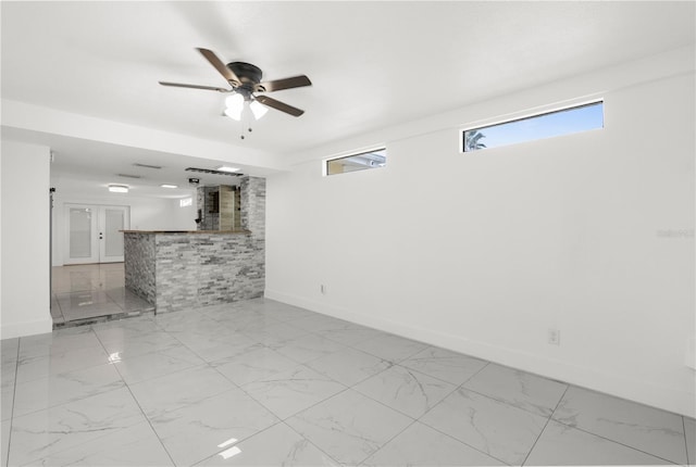 unfurnished living room featuring ceiling fan