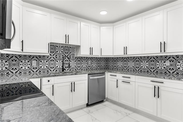 kitchen featuring dark stone countertops, backsplash, white cabinets, and appliances with stainless steel finishes