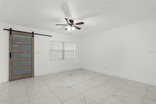 unfurnished room with a barn door and ceiling fan