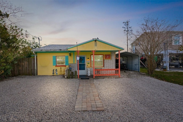 view of front of property featuring a carport and covered porch