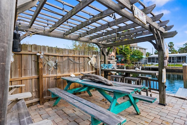 view of dock featuring a water view and a pergola