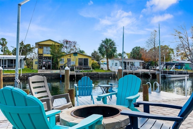 dock area with a water view and an outdoor fire pit