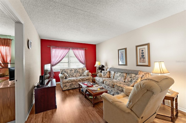 living room featuring a textured ceiling and hardwood / wood-style floors