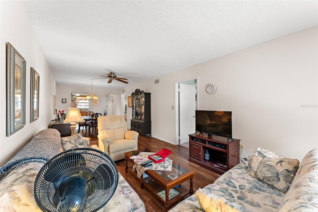 living room featuring a textured ceiling, wood finished floors, visible vents, and a ceiling fan