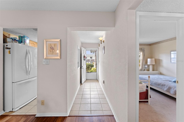 hallway with light hardwood / wood-style flooring