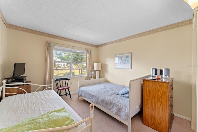 bedroom featuring carpet floors, baseboards, and a textured ceiling