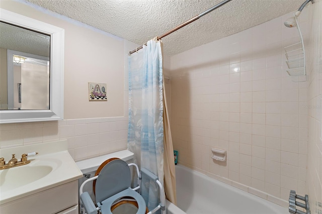 bathroom featuring a textured ceiling, shower / bath combo, tasteful backsplash, and vanity