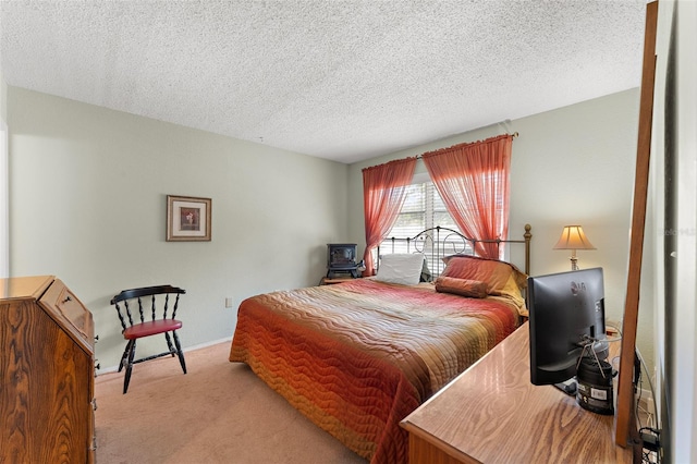 bedroom featuring a textured ceiling and light carpet