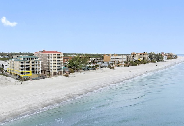 aerial view with a water view and a beach view