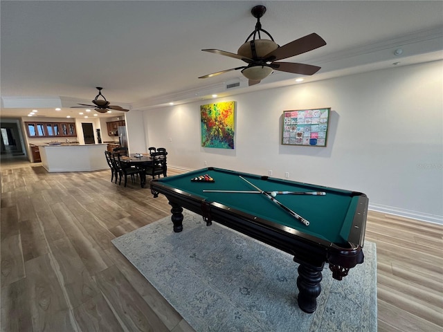 rec room featuring ceiling fan, recessed lighting, wood finished floors, and crown molding