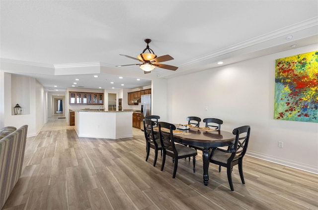 dining room featuring light wood-type flooring, ornamental molding, and recessed lighting