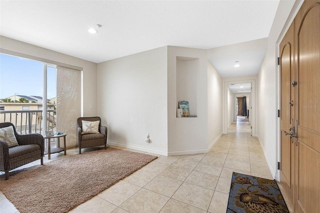 living area featuring light tile patterned floors, recessed lighting, and baseboards