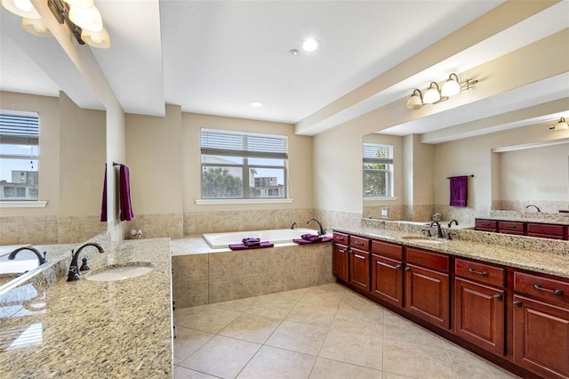 full bathroom with vanity, a bath, and tile patterned floors