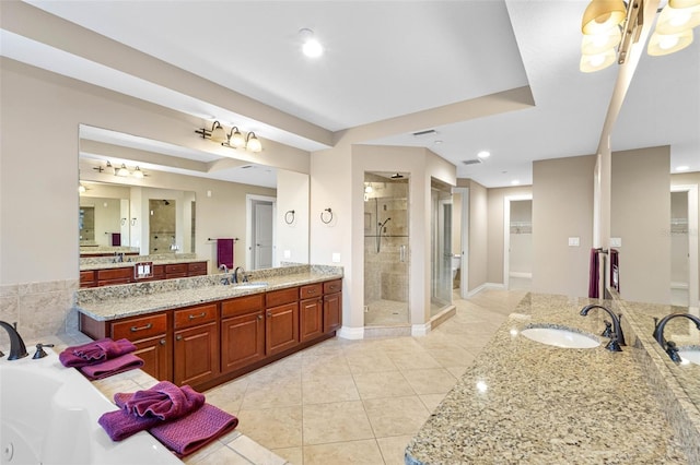 bathroom featuring a bath, tile patterned flooring, a shower stall, and a sink