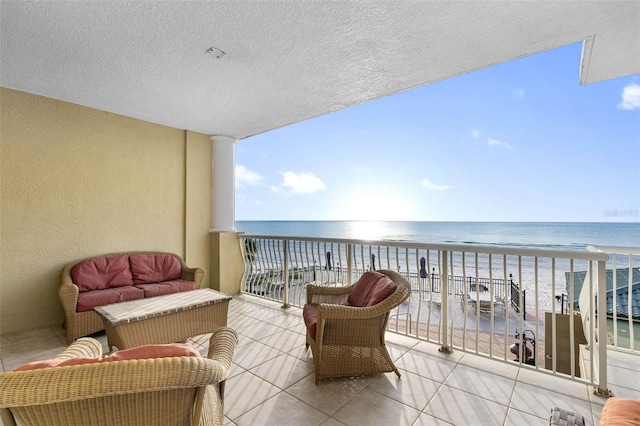 balcony with a beach view and a water view