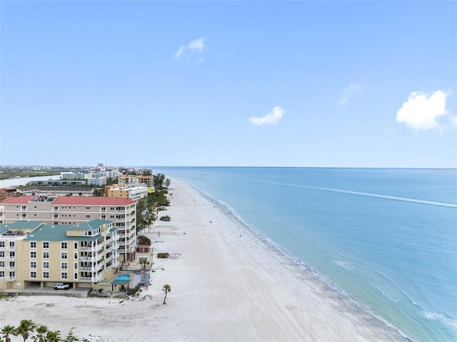 birds eye view of property featuring a water view and a beach view