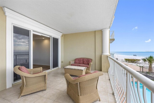 balcony with a view of the beach and a water view