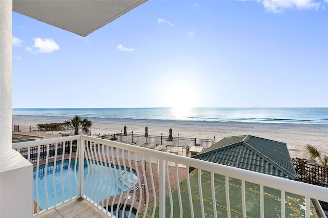 balcony featuring a water view and a beach view