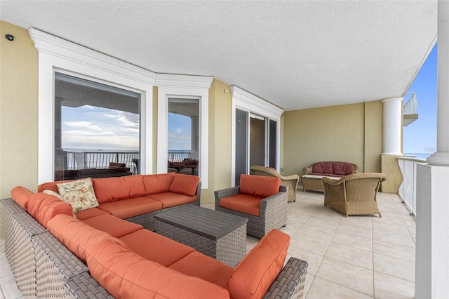 view of patio featuring an outdoor hangout area and a balcony