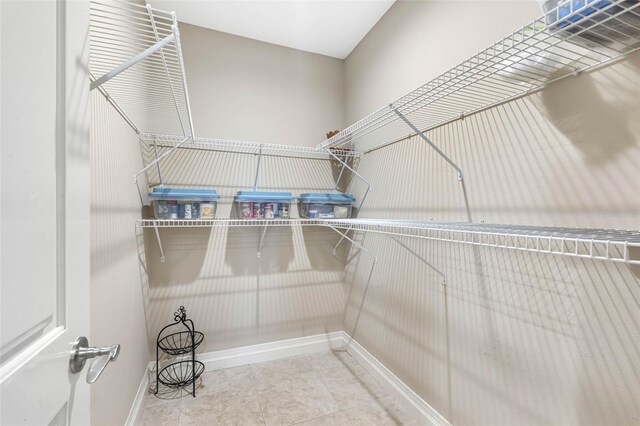 walk in closet featuring tile patterned flooring