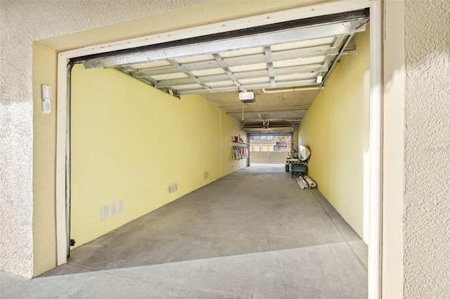 garage with visible vents and a garage door opener