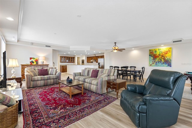 living room with recessed lighting, visible vents, ceiling fan, and light wood finished floors