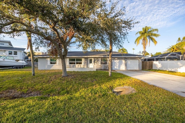 ranch-style home with a garage and a front lawn