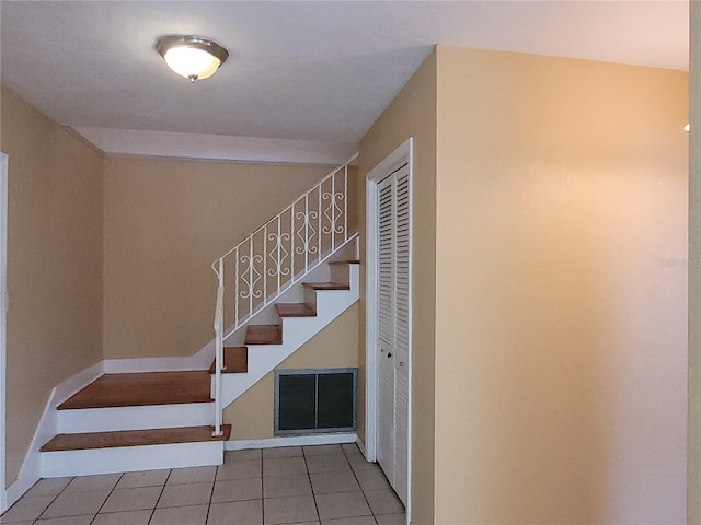 stairs featuring tile patterned floors