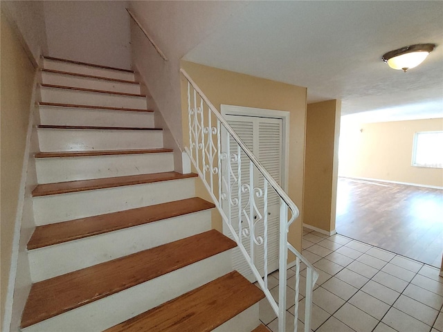 stairs featuring tile patterned floors