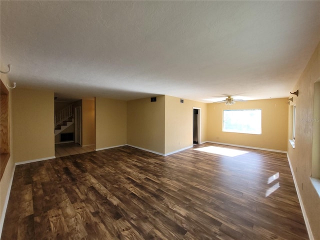 unfurnished room with dark hardwood / wood-style floors and ceiling fan