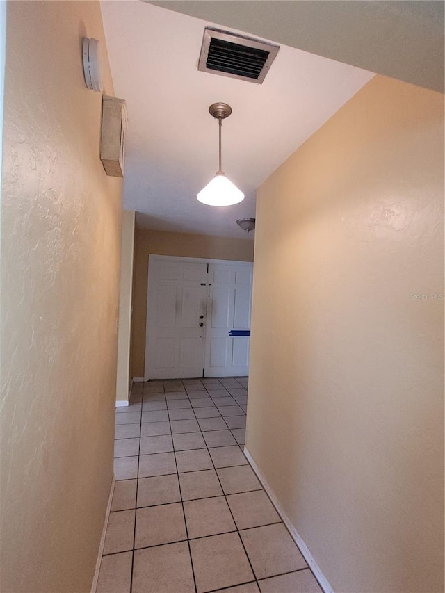 hall featuring light tile patterned floors