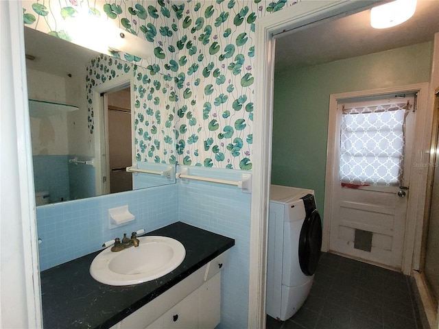 bathroom featuring washer / dryer, tile walls, backsplash, tile patterned flooring, and vanity