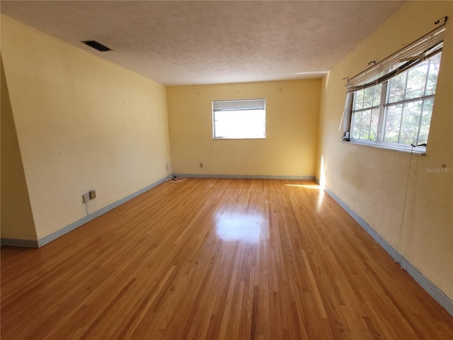 unfurnished room with light hardwood / wood-style floors