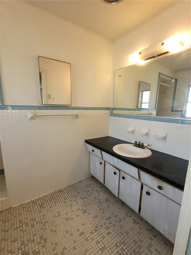 bathroom with vanity, tile patterned flooring, and tile walls