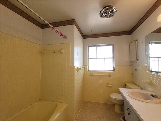 full bathroom with vanity, plenty of natural light, and tile walls