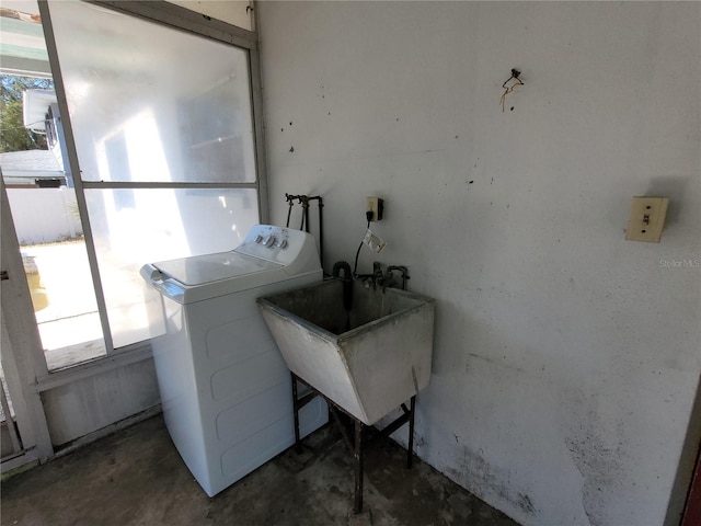 laundry area with sink, washer and dryer, and a healthy amount of sunlight