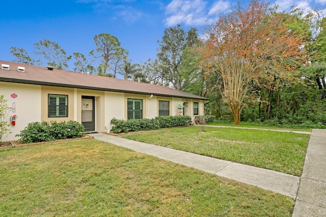 ranch-style home featuring a front yard