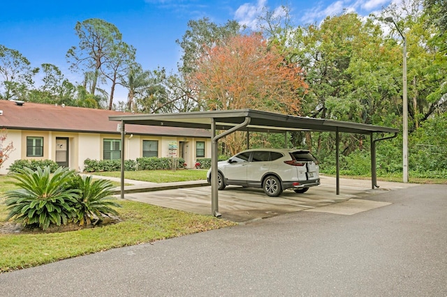 view of parking featuring a carport and a yard