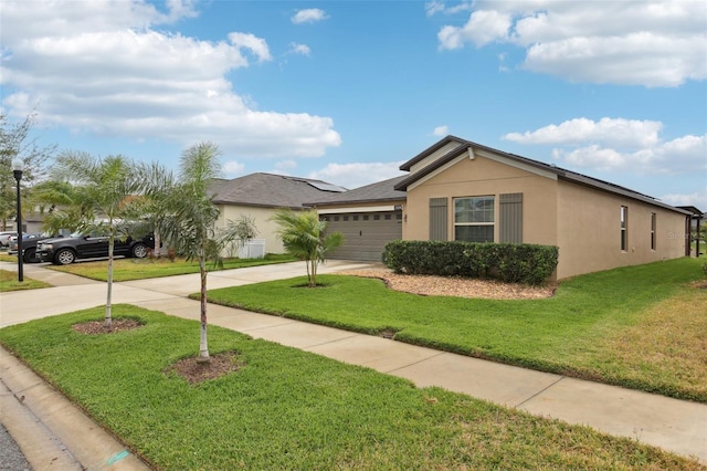 ranch-style house featuring a garage and a front lawn